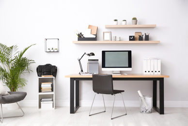 Modern computer on table in office interior. Stylish workplace