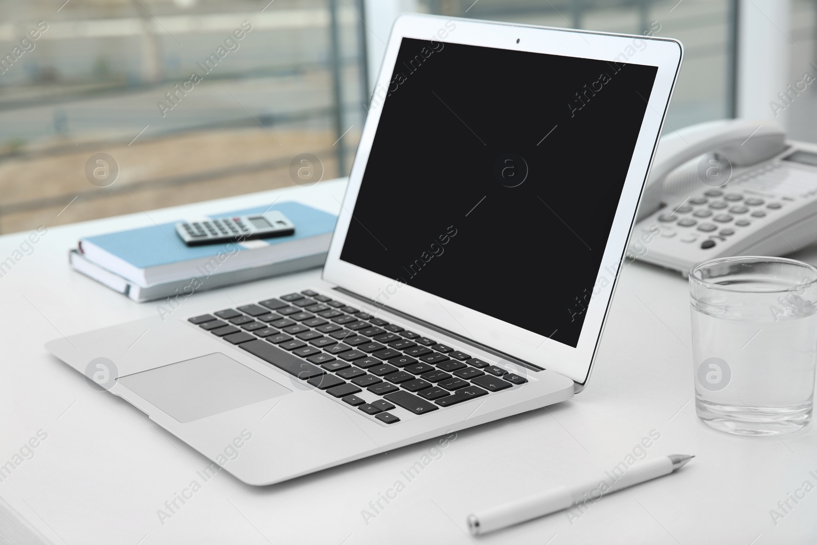 Photo of Stylish workplace with modern laptop on desk