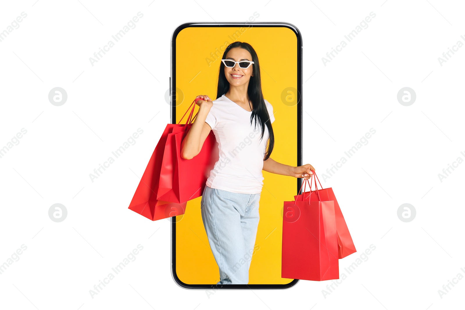 Image of Online shopping. Happy woman with paper bags looking out from smartphone on white background
