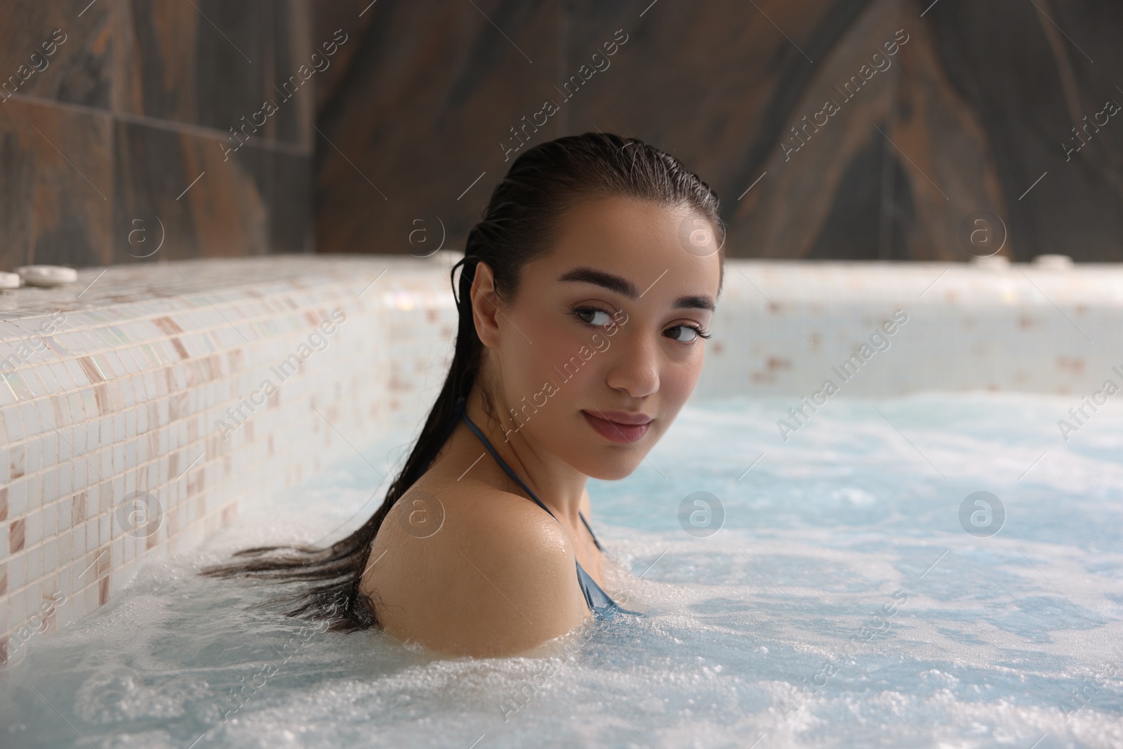 Photo of Beautiful woman relaxing in spa swimming pool