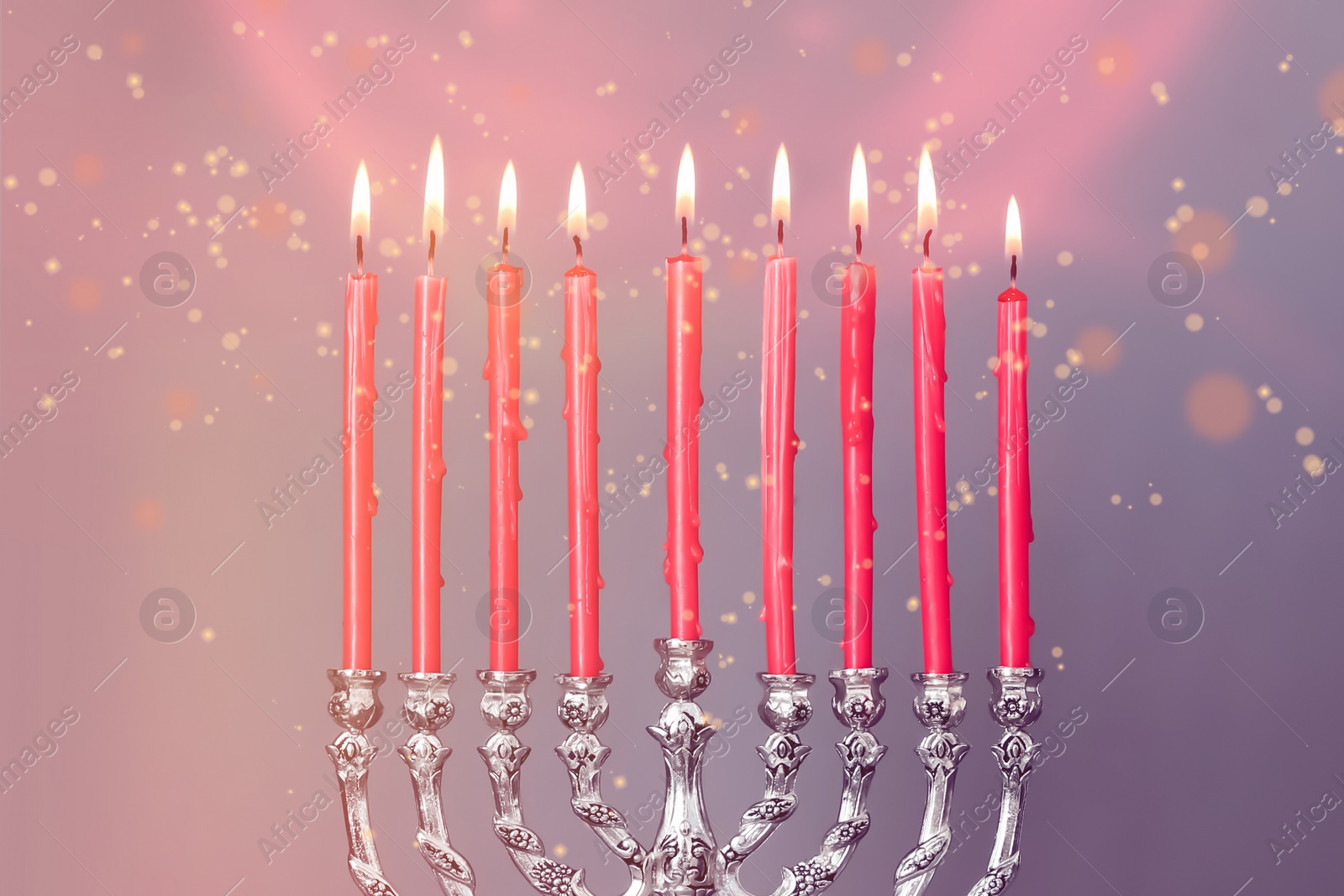 Image of Silver menorah with burning candles on color background, closeup. Hanukkah celebration