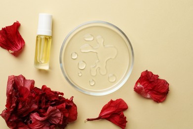Photo of Petri dish with cosmetic product and flowers on beige background, flat lay
