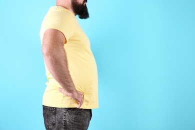 Photo of Fat man on color background, space for text. Weight loss