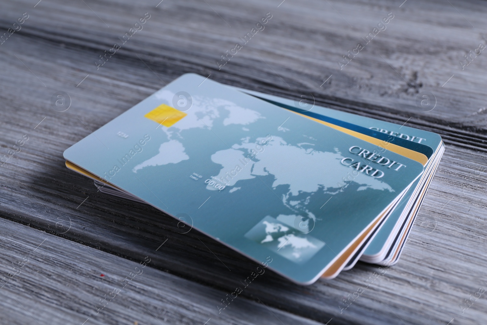 Photo of Credit cards on grey wooden table, closeup