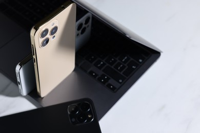 Photo of Many different modern gadgets on white table, closeup