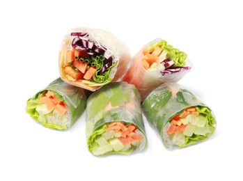 Different delicious spring rolls wrapped in rice paper on white background