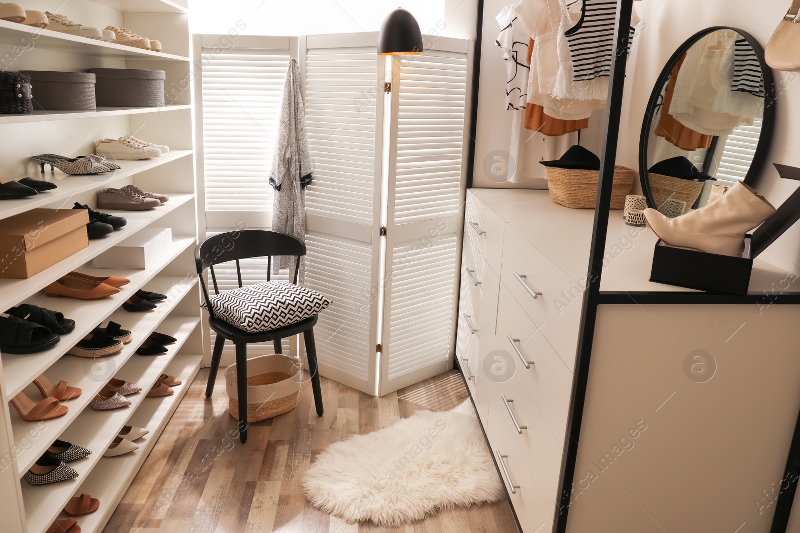 Photo of Dressing room interior with storage rack for shoes and accessories