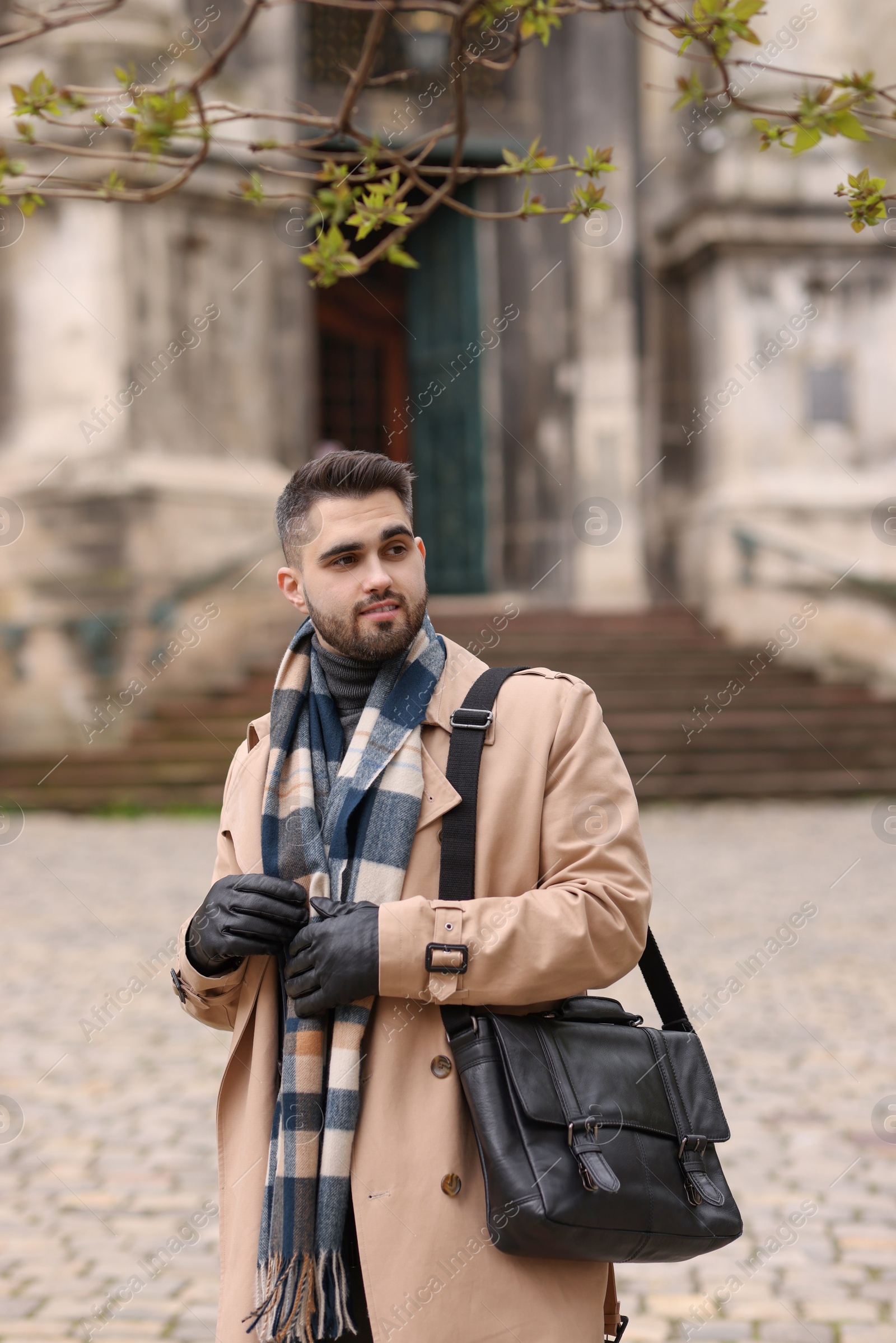 Photo of Handsome man in warm scarf on city street