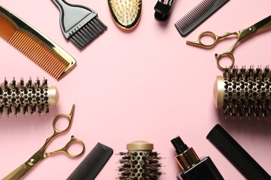 Photo of Frame made of professional hair dresser tools on pink background, flat lay. Space for text