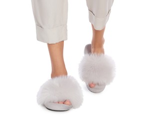 Woman in fluffy slippers on white background, closeup