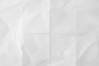 Sheet of folded white paper as background, top view