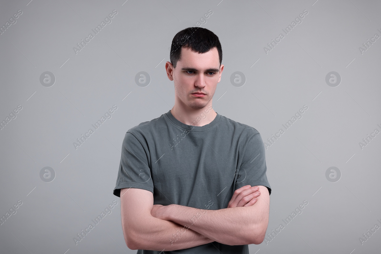 Photo of Portrait of sad man on grey background