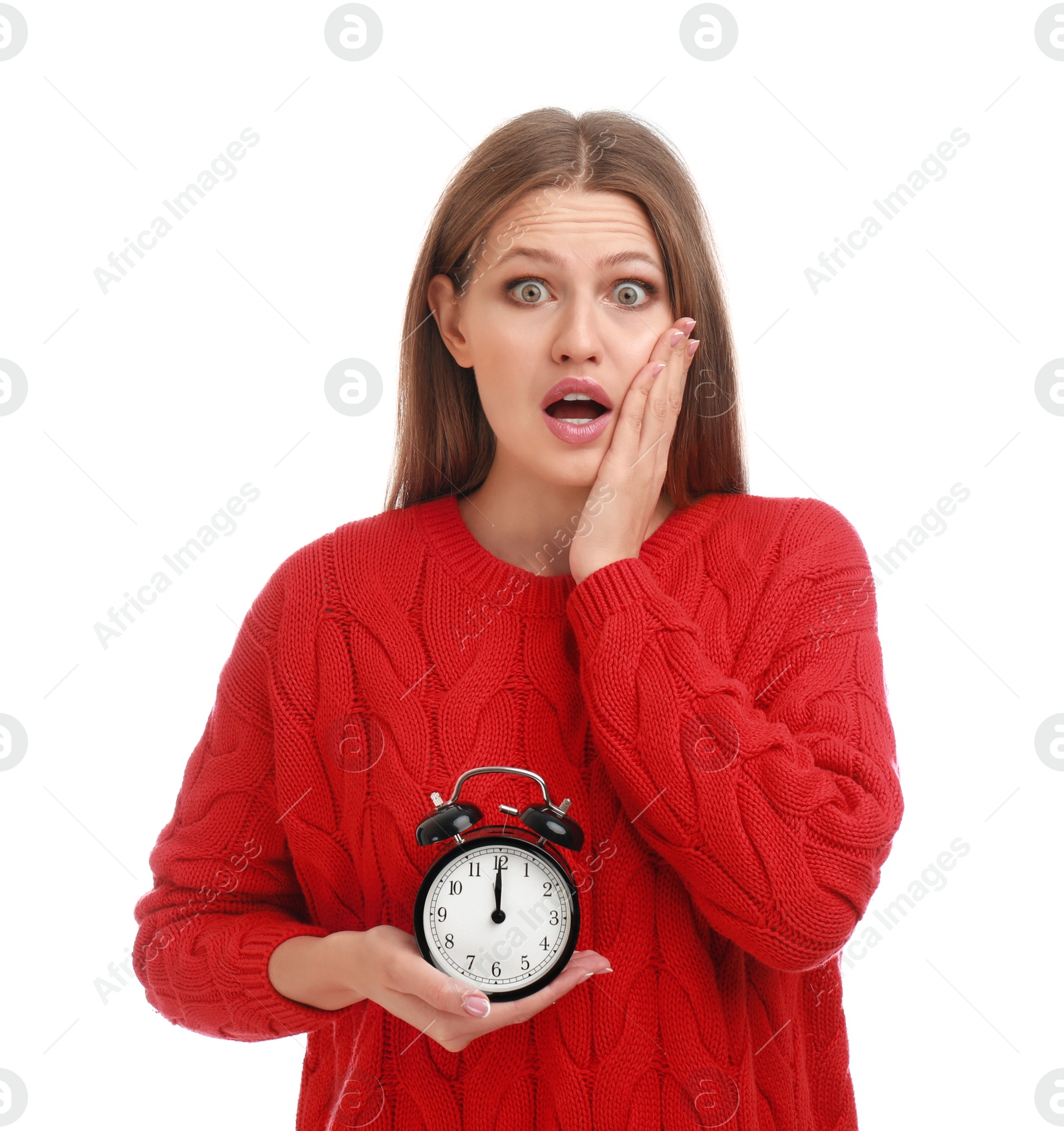 Photo of Emotional young woman with alarm clock on white background. Christmas time