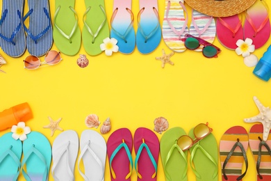 Photo of Flat lay composition with summer beach accessories on yellow background. Space for text