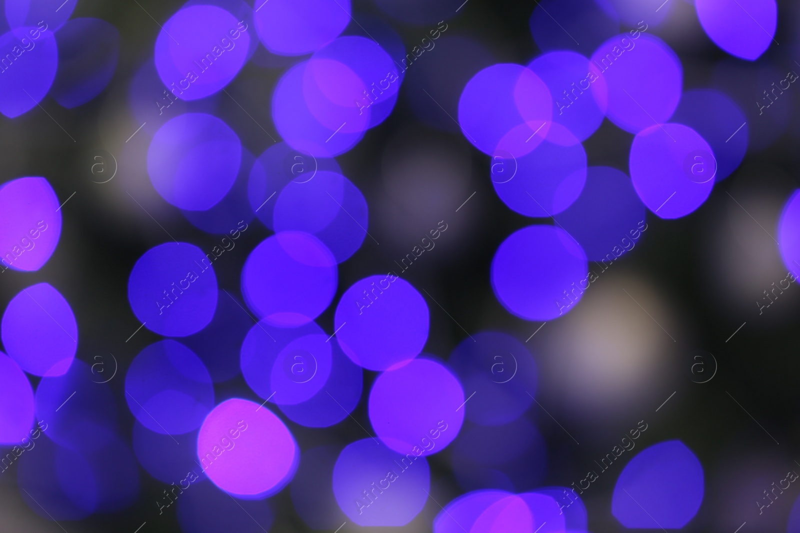 Photo of Blurred view of glowing Christmas lights as background. Festive mood