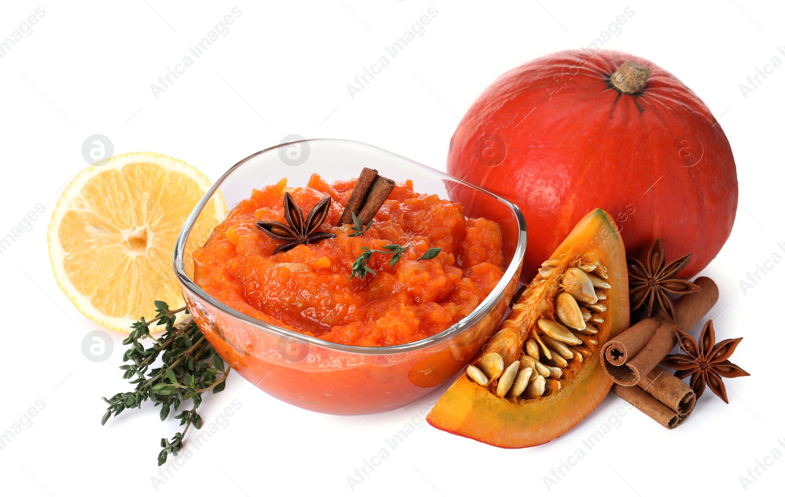 Photo of Glass bowl with pumpkin jam and ingredients on white background