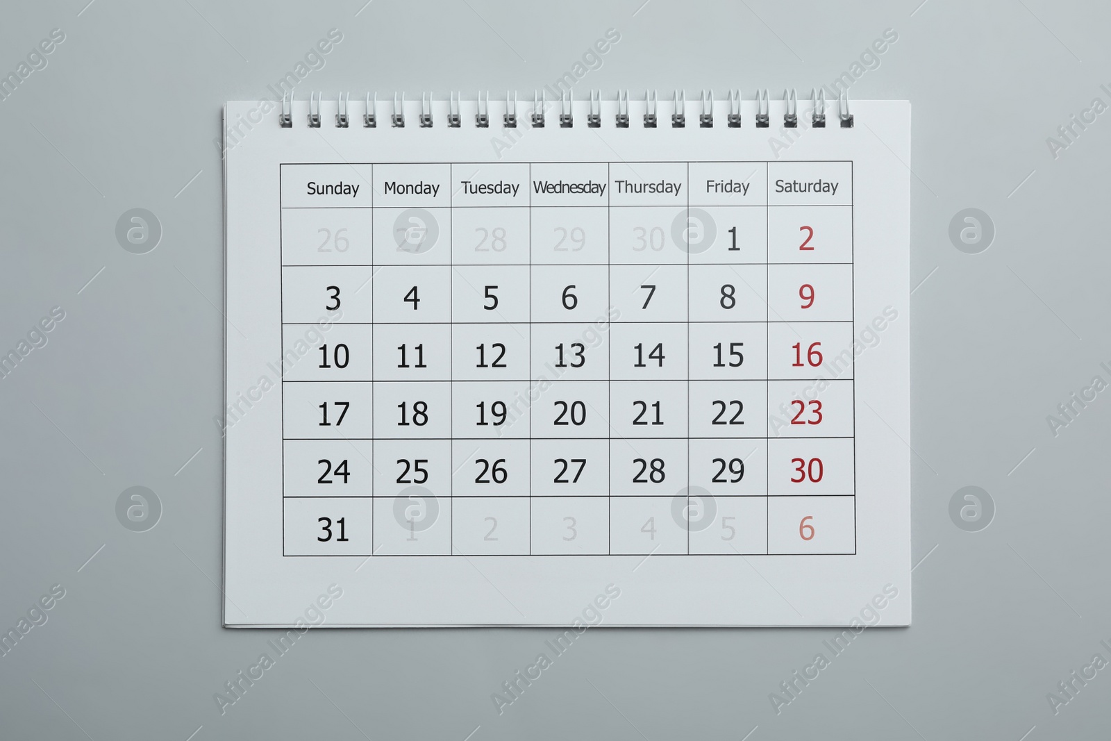 Photo of Paper calendar on light grey background, top view