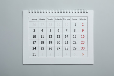 Photo of Paper calendar on light grey background, top view