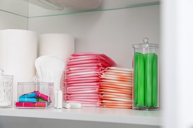 Photo of Storage of different feminine hygiene products in cabinet