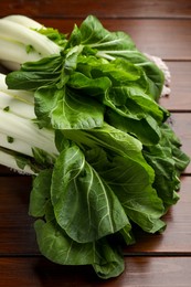 Photo of Fresh green pak choy cabbages on wooden table, closeup