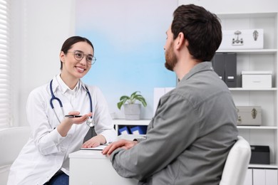 Doctor consulting patient during appointment in clinic