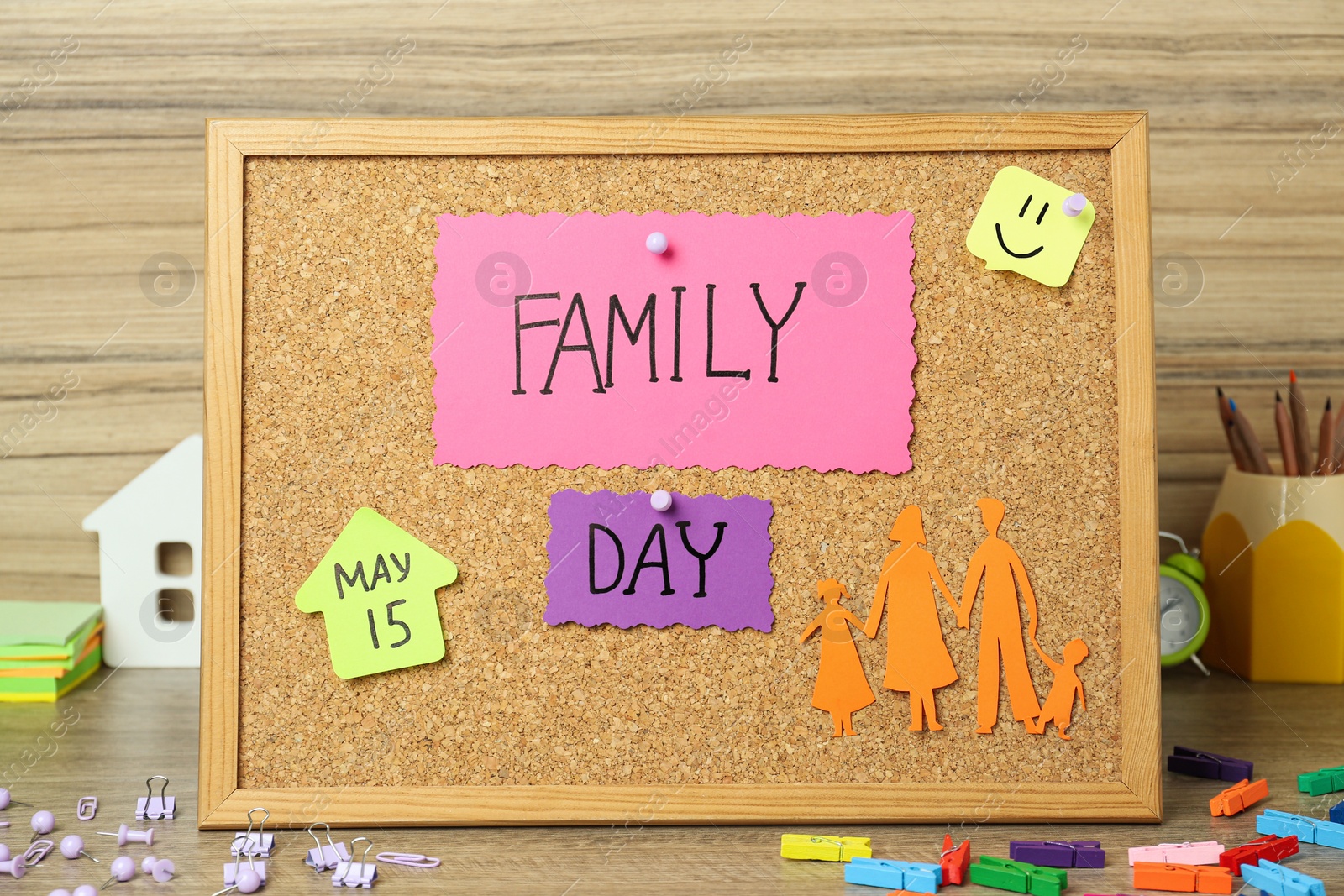 Photo of Happy Family Day. Composition with cork board and stationery on wooden table