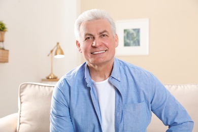 Mature man using video chat at home, view from web camera