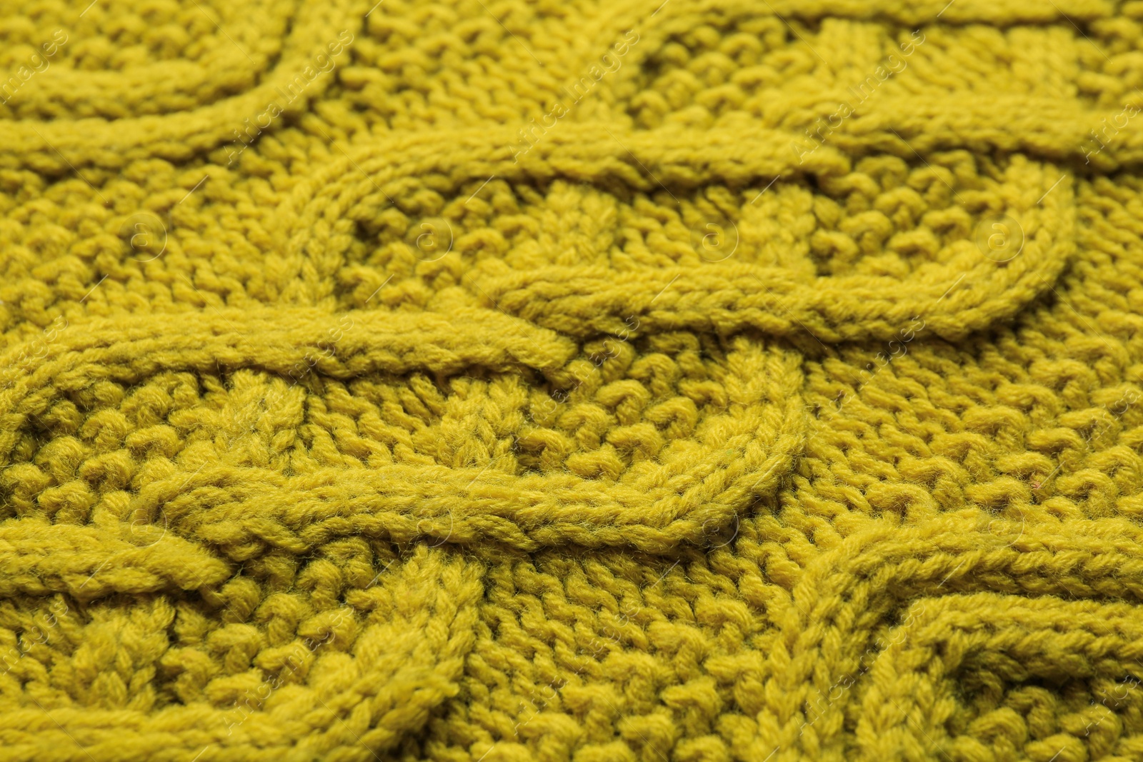 Photo of Knitted fabric with beautiful pattern as background, closeup