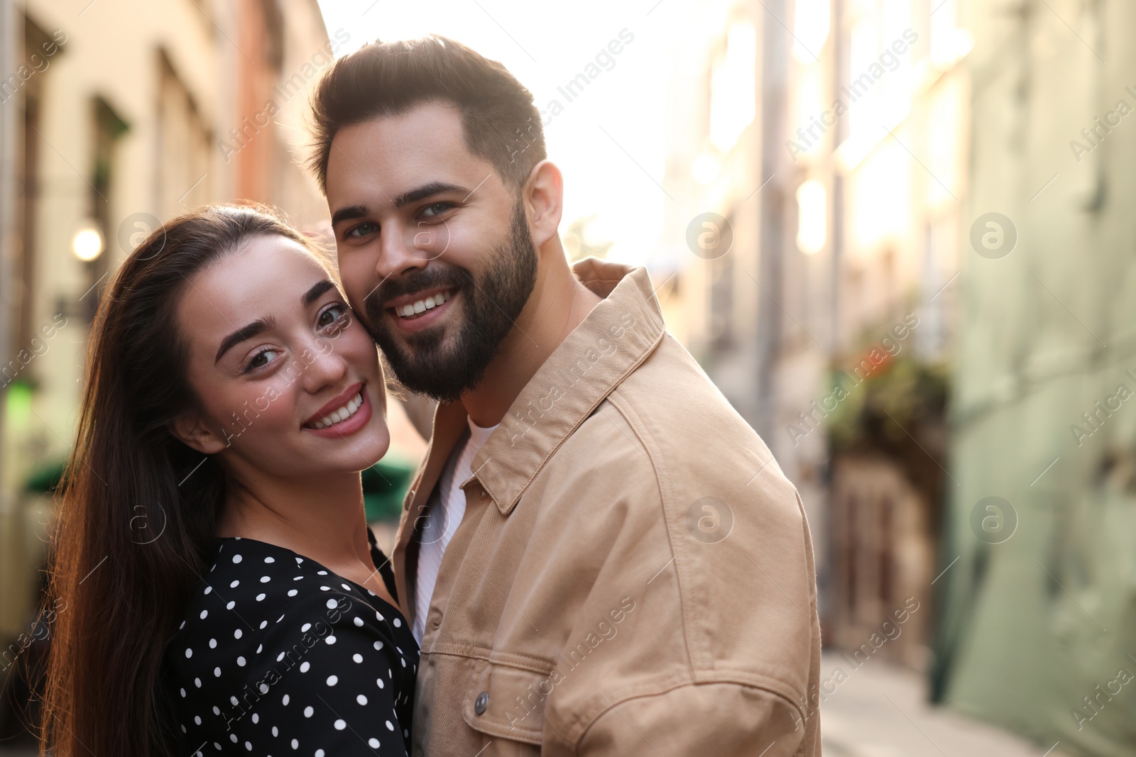 Photo of Lovely couple dancing together on city street, space for text