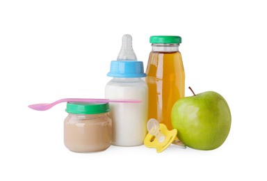 Healthy baby food, bottles with juice, milk, apple and pacifier on light grey background