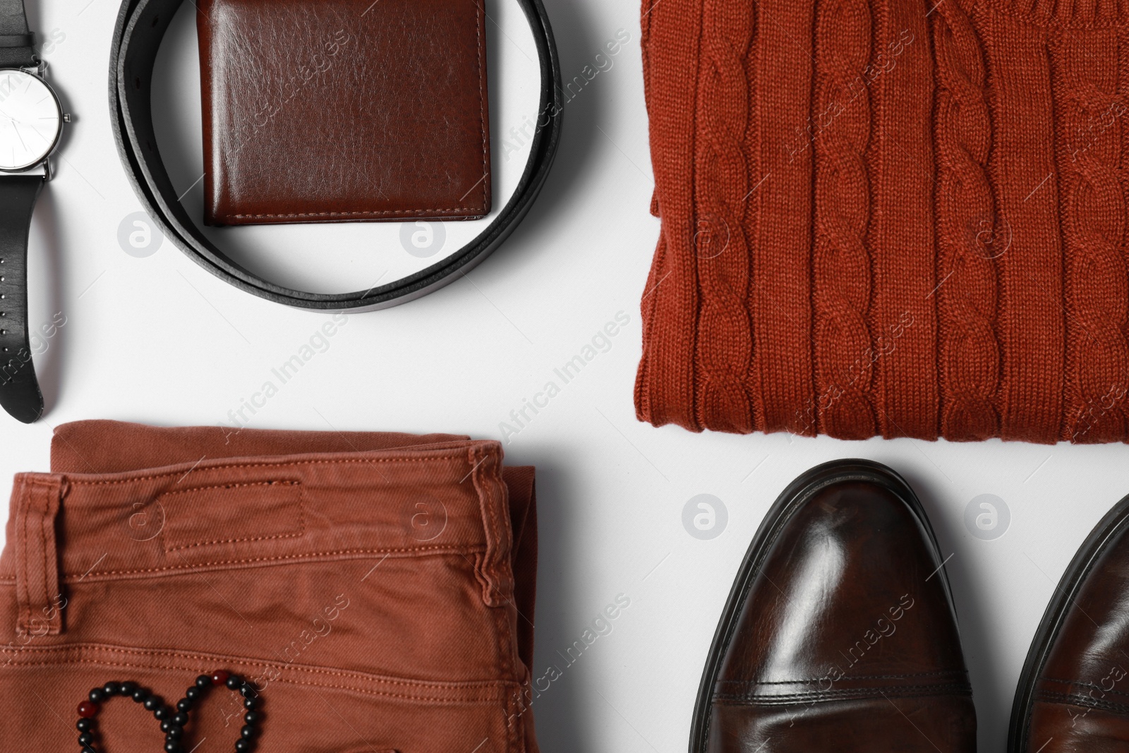Photo of Stylish male autumn outfit and accessories on white background, flat lay. Trendy warm clothes