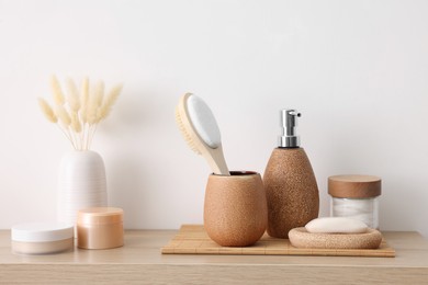 Photo of Different bath accessories and personal care products on wooden table