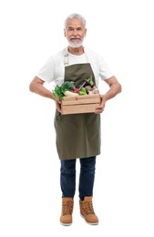 Photo of Harvesting season. Farmer holding wooden crate with vegetables on white background