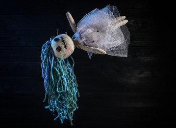 Photo of Female voodoo doll with pins on dark background