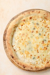 Photo of Delicious cheese pizza on beige textured table, top view