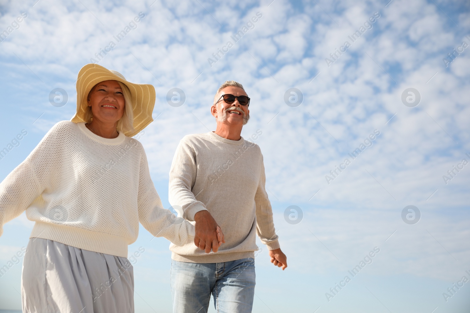 Photo of Mature couple spending time together on sea beach