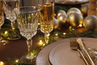 Photo of Table setting with festive lights and Christmas decor