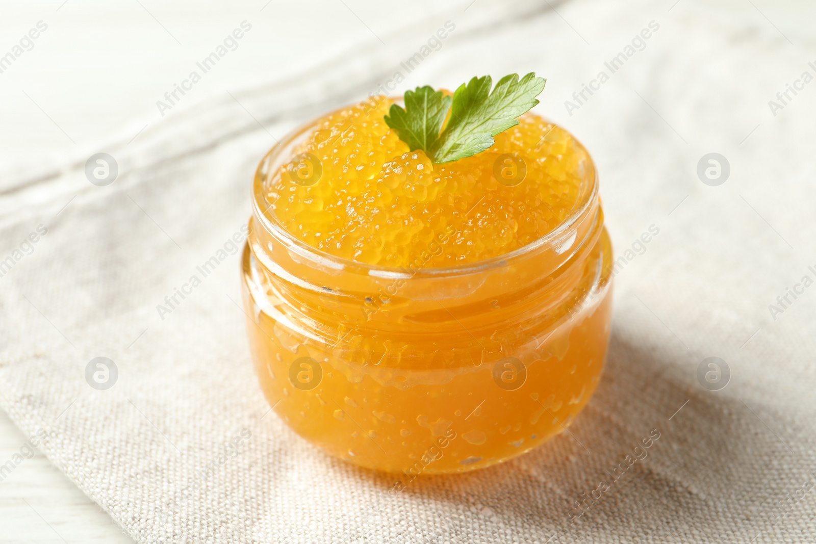 Photo of Fresh pike caviar in glass jar on table, closeup