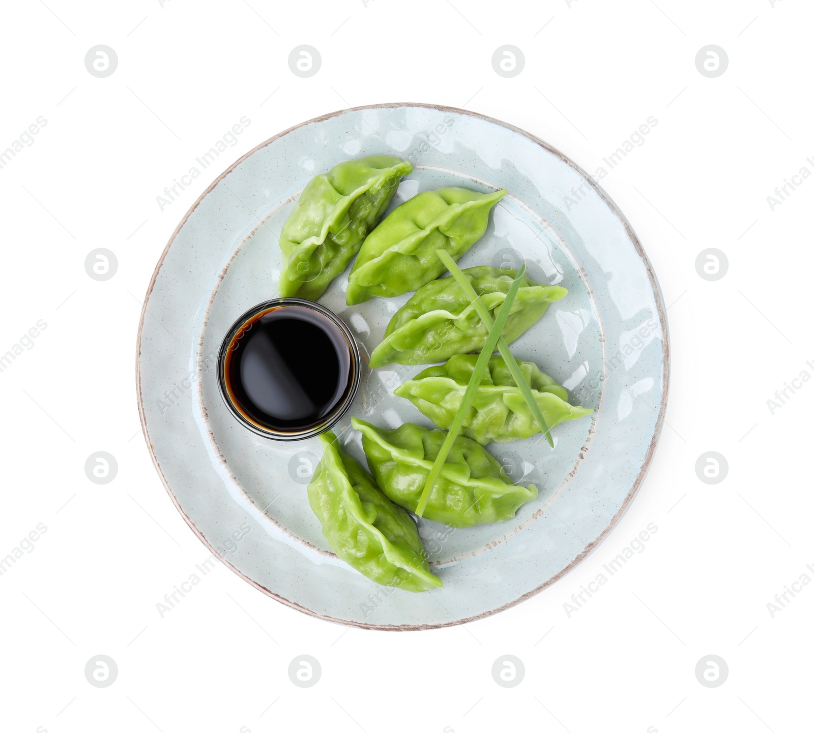 Photo of Delicious green dumplings (gyozas) and soy sauce isolated on white, top view