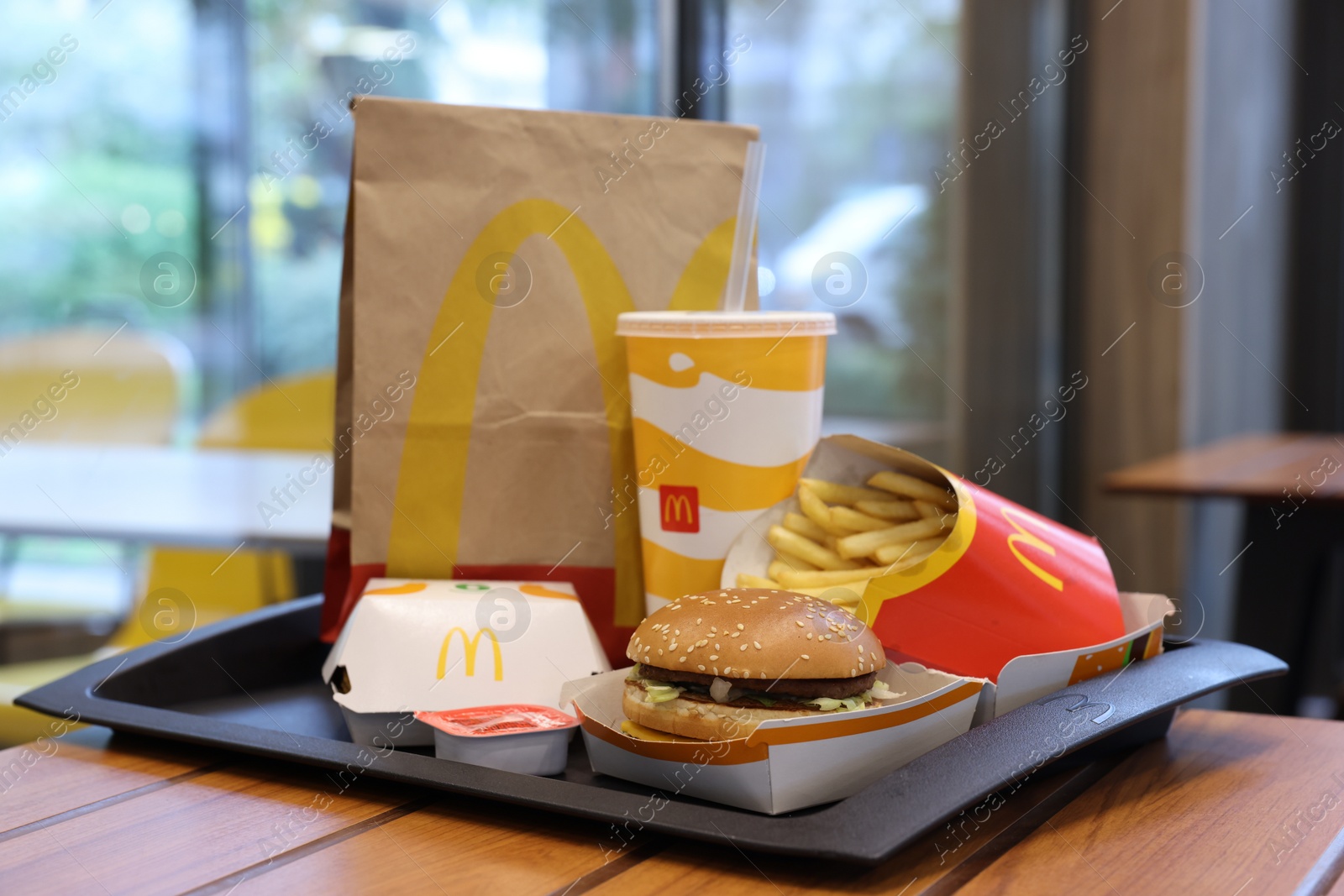 Photo of Lviv, Ukraine - October 9, 2023: McDonald's menu on wooden table in restaurant