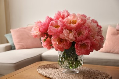 Photo of Beautiful pink peonies in vase on table at home. Interior design