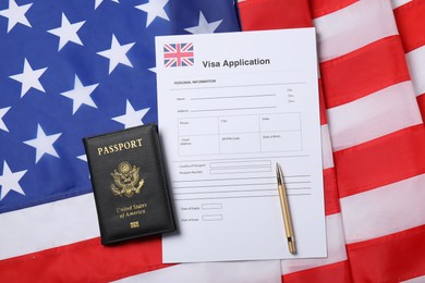 Photo of Immigration to USA. Visa application form, passport and pen on flag, flat lay