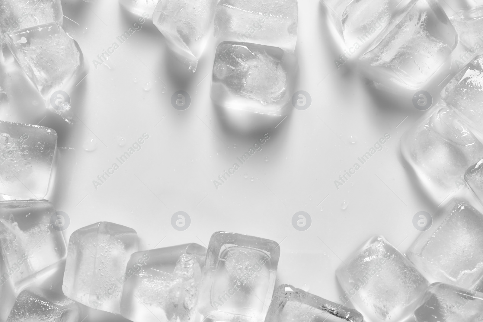 Photo of Frame made of ice cubes on white background, top view. Space for text