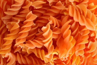 Photo of Tasty raw pasta as background, closeup view