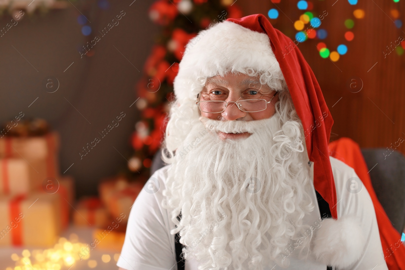 Photo of Authentic Santa Claus with bushy beard indoors