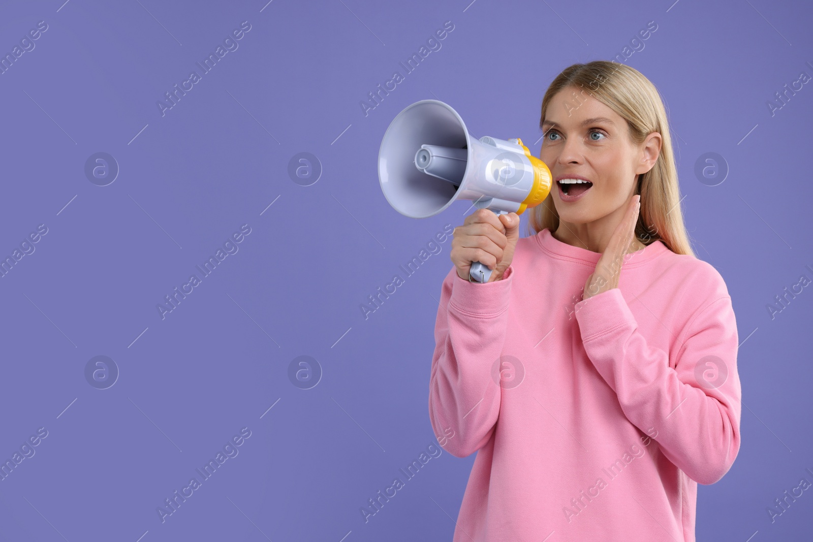 Photo of Special promotion. Woman shouting in megaphone on purple background. Space for text