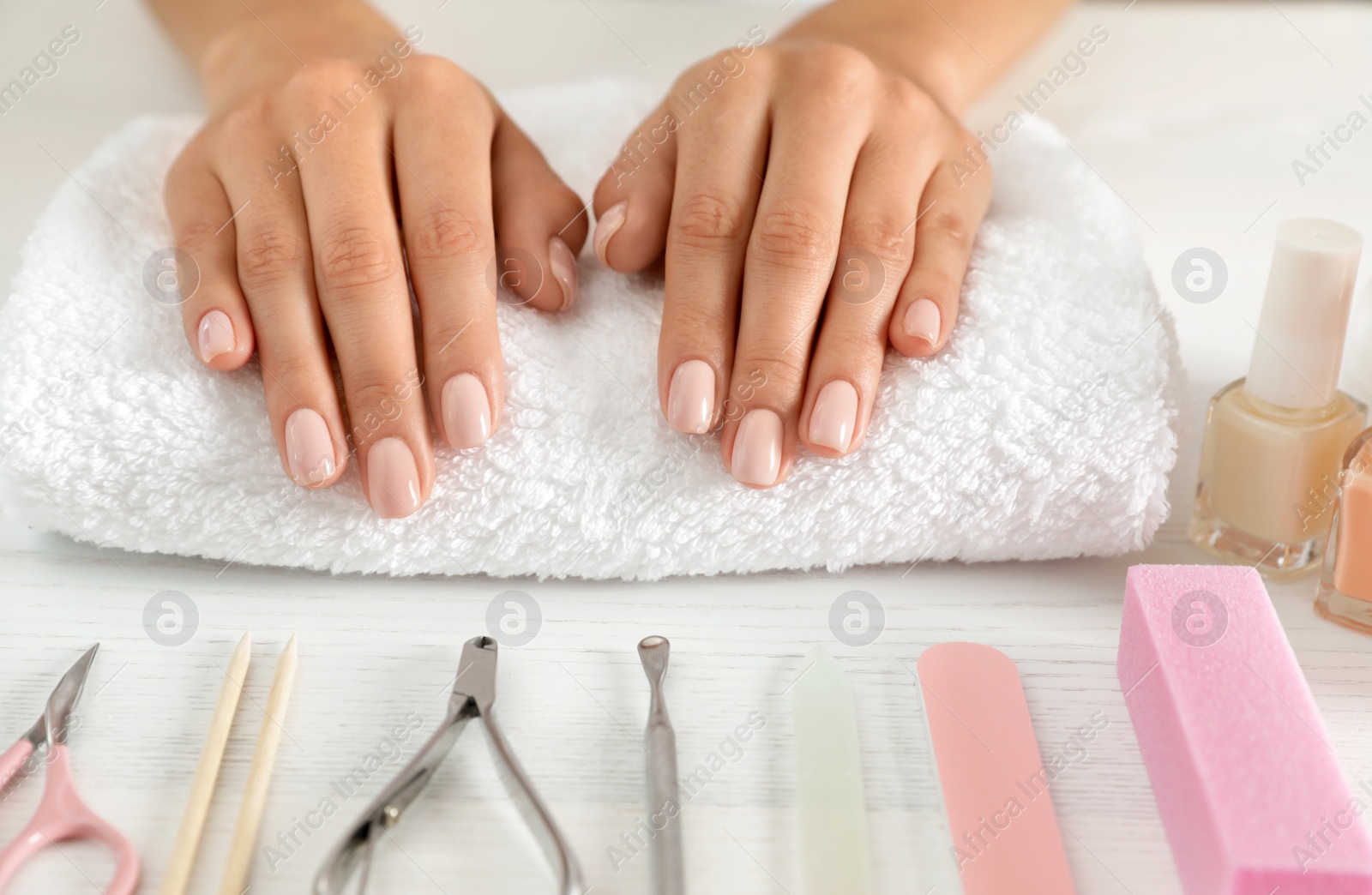 Photo of Woman waiting for manicure and tools on table, closeup. Spa treatment