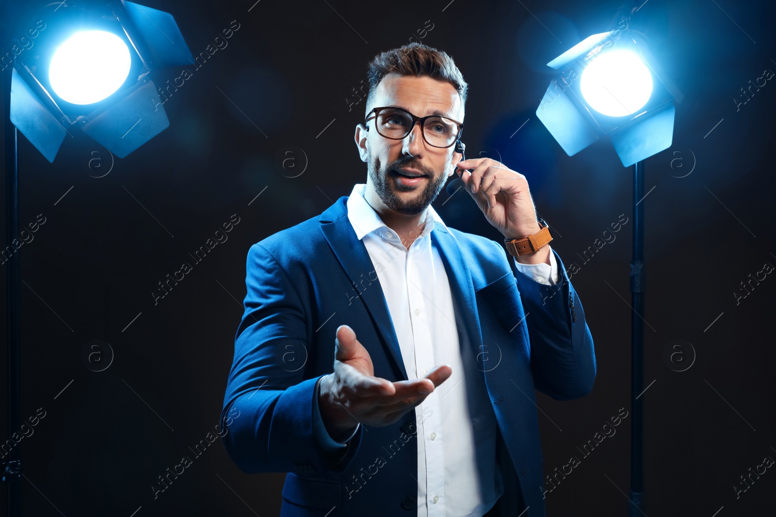 Photo of Motivational speaker with headset performing on stage