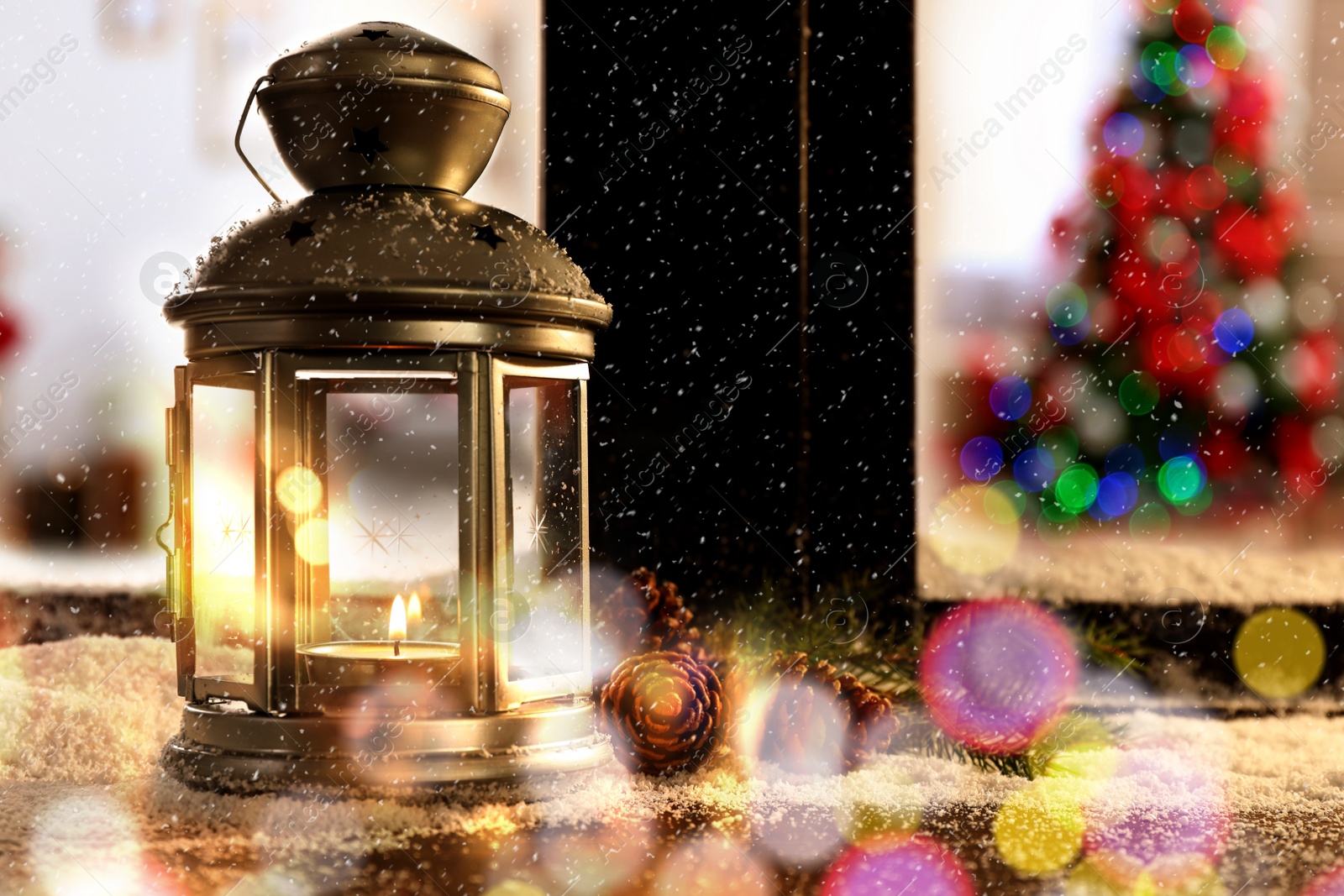 Image of Lantern with candle, fir branches and pine cones near window outdoors. Christmas eve