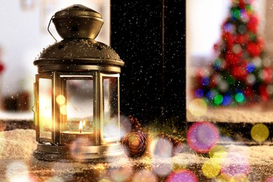 Image of Lantern with candle, fir branches and pine cones near window outdoors. Christmas eve